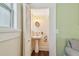 Compact half bathroom with pedestal sink and vintage-style fixtures at 834 26Th N Ave, St Petersburg, FL 33704