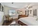 Bedroom with hardwood floors, a ceiling fan, a comfy chair, and a large window with natural light at 834 26Th N Ave, St Petersburg, FL 33704