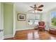 Bright bedroom with hardwood floors, chair, fan, and natural light flooding through the windows at 834 26Th N Ave, St Petersburg, FL 33704