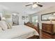 Serene bedroom with hardwood floors, a comfy bed, and a well-lit dresser at 834 26Th N Ave, St Petersburg, FL 33704