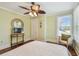 Cozy bedroom with a ceiling fan, light-green walls, wood floor, and window providing ample natural light at 834 26Th N Ave, St Petersburg, FL 33704