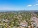 Expansive aerial view showcasing the city skyline, a tranquil lake, and neighborhood of homes at 834 26Th N Ave, St Petersburg, FL 33704