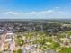 A far reaching neighborhood view from above displays lush greenery, homes, and a clear sky at 834 26Th N Ave, St Petersburg, FL 33704