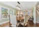 Open concept dining room with hardwood floors, chandelier, and views into the living room and kitchen at 834 26Th N Ave, St Petersburg, FL 33704