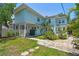 Exterior showcasing a two-story home with covered parking, tropical landscaping, and a paved walkway at 834 26Th N Ave, St Petersburg, FL 33704