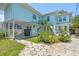Exterior view of a charming two-story home with a lush yard, and a covered parking area at 834 26Th N Ave, St Petersburg, FL 33704