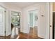 Upstairs hallway with wood floors, showcasing doorways leading to other rooms at 834 26Th N Ave, St Petersburg, FL 33704