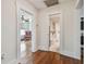 Hallway view leading to a bedroom and bathroom with original hardwood floors and white trim at 834 26Th N Ave, St Petersburg, FL 33704