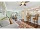Inviting living room featuring hardwood floors, decorative rug, and open access to the dining area at 834 26Th N Ave, St Petersburg, FL 33704
