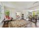 Spacious living room boasts hardwood floors, large windows and flows into the dining room for seamless entertaining at 834 26Th N Ave, St Petersburg, FL 33704