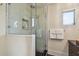 Glass-enclosed shower with white tile, built-in shelving, and modern fixtures at 834 26Th N Ave, St Petersburg, FL 33704
