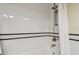 Classic white tiled shower with black accent tiles and a brushed nickel shower head at 834 26Th N Ave, St Petersburg, FL 33704