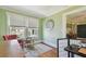 Cozy sitting area with ample light, hardwood floors, vintage chair, and an area rug at 834 26Th N Ave, St Petersburg, FL 33704