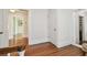 Upstairs hallway featuring hardwood floors, white walls and trim, and doorways to other rooms at 834 26Th N Ave, St Petersburg, FL 33704
