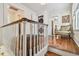 Hallway with hardwood floors, white trim, stackable washer/dryer, and decorative armchair at 834 26Th N Ave, St Petersburg, FL 33704