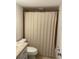 Compact bathroom features a toilet, shower with curtain, and vanity for essential functionality at 845 S Gulfview Blvd # 110, Clearwater Beach, FL 33767