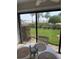 Inviting dining area with table for four and scenic views of the community's green space and waterfront beyond at 845 S Gulfview Blvd # 110, Clearwater Beach, FL 33767