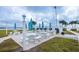Community grilling area featuring multiple grills, picnic tables, and scenic water views at 845 S Gulfview Blvd # 110, Clearwater Beach, FL 33767