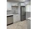 Recently updated kitchen features stainless steel dishwasher and fridge surrounded by modern cabinets at 845 S Gulfview Blvd # 110, Clearwater Beach, FL 33767