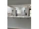 Bright kitchen features white cabinets, stainless steel appliances and a breakfast bar for casual dining at 845 S Gulfview Blvd # 110, Clearwater Beach, FL 33767