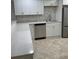 Renovated kitchen featuring stainless steel dishwasher and sink with a large kitchen counter top space at 845 S Gulfview Blvd # 110, Clearwater Beach, FL 33767