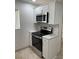 Updated kitchen with stainless steel appliances, bright white cabinets and counter space for meal preparation at 845 S Gulfview Blvd # 110, Clearwater Beach, FL 33767