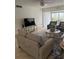 Well-lit living room features a large television, comfortable seating and stylish decor, with access to an outdoor dining area at 845 S Gulfview Blvd # 110, Clearwater Beach, FL 33767