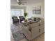 Bright living room featuring comfortable seating, stylish decor, and access to an outdoor dining area at 845 S Gulfview Blvd # 110, Clearwater Beach, FL 33767