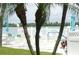 Relaxing pool area with white lounge chairs, palm trees, and views of the water at 845 S Gulfview Blvd # 110, Clearwater Beach, FL 33767