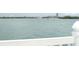 Scenic water view showcasing a bridge and distant skyline from a waterfront property with a white railing at 845 S Gulfview Blvd # 110, Clearwater Beach, FL 33767