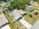The aerial view showcases this home's roof, long driveway, and spacious fenced-in backyard with a swimming pool at 10512 Red Coach St, Spring Hill, FL 34608
