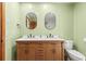 Bathroom featuring double sinks, wooden drawers, and black fixtures at 10512 Red Coach St, Spring Hill, FL 34608