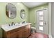 Updated bathroom featuring a double vanity and a tile shower at 10512 Red Coach St, Spring Hill, FL 34608