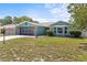 Attractive one-story home featuring an attached garage, well-kept lawn, and appealing architectural details at 10512 Red Coach St, Spring Hill, FL 34608