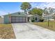 Lovely one-story home with an attached garage, showcasing a manicured lawn and inviting curb appeal at 10512 Red Coach St, Spring Hill, FL 34608