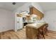 Kitchen with wooden cabinets, microwave and refrigerator and bar stool area at 10512 Red Coach St, Spring Hill, FL 34608