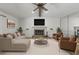 Stylishly furnished living room with a fireplace, contemporary decor, and ample seating for entertaining guests at 10512 Red Coach St, Spring Hill, FL 34608