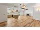 Spacious living area with an open layout, featuring hardwood floors, a fireplace, and ample natural light at 10512 Red Coach St, Spring Hill, FL 34608