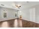 Spacious main bedroom with hardwood floors, fan and natural light at 10512 Red Coach St, Spring Hill, FL 34608