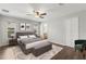 Spacious main bedroom with hardwood floors, fan and bench seating at 10512 Red Coach St, Spring Hill, FL 34608