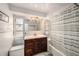 Bathroom featuring a bathtub and shower combo, stylish vanity, and contemporary lighting at 1179 Lazy Lake W Rd, Dunedin, FL 34698