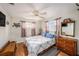 Cozy bedroom featuring a queen-sized bed, dresser and hardwood floors at 1179 Lazy Lake W Rd, Dunedin, FL 34698