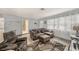 Inviting living room with stylish decor, tile flooring, and a cozy sectional sofa at 1179 Lazy Lake W Rd, Dunedin, FL 34698