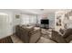 Cozy living room featuring a comfortable sofa, tile flooring, and ample natural light at 1179 Lazy Lake W Rd, Dunedin, FL 34698