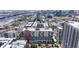 An aerial view of a modern apartment building complex with blue balcony accents in a lively city setting at 1208 E Kennedy Blvd # 831, Tampa, FL 33602