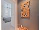 Hallway view into bedroom with ceiling fan, neutral colors, and modern wooden wall decor at 1208 E Kennedy Blvd # 831, Tampa, FL 33602