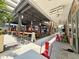 Outdoor restaurant seating area with shaded tables and a vibrant atmosphere, perfect for a leisurely meal at 1208 E Kennedy Blvd # 831, Tampa, FL 33602