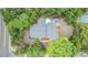 Aerial view showcasing the property's layout, landscaping, backyard, deck and proximity to surrounding neighborhood at 1225 15Th St, Palm Harbor, FL 34683