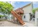Backyard featuring a wooden deck with stairs leading to the yard and a ground level entry door at 1225 15Th St, Palm Harbor, FL 34683