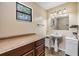 Bathroom featuring wooden cabinets and a pedestal sink at 1225 15Th St, Palm Harbor, FL 34683